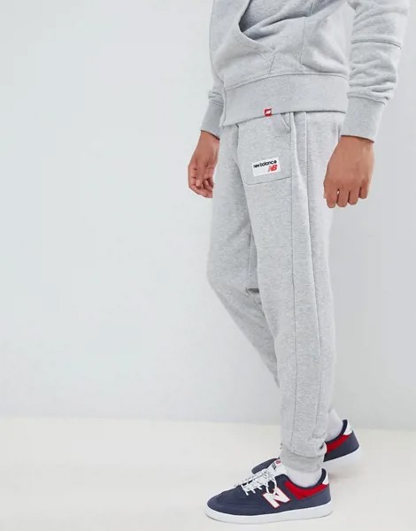 Серые джоггеры с маленьким логотипом New Balance MP83515_AG-Серый