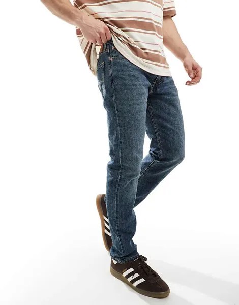 Стильные джинсы из зауженного кроя Levi's 502 темно-синего цвета
