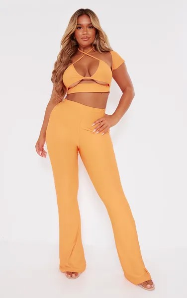 PrettyLittleThing Оранжевые обтягивающие расклешенные брюки с низкой посадкой Shape