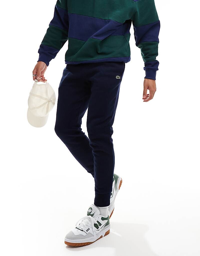 Темно-синие узкие спортивные брюки с логотипом Lacoste