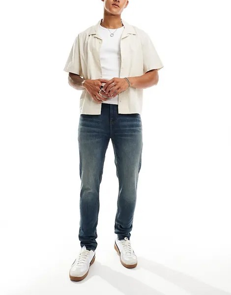 ASOS DESIGN – темно-синие джинсы скинни с желтым эффектом размытия