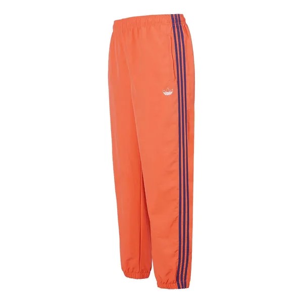 Спортивные штаны adidas originals Woven Three Stripe Warm up Pants, оранжевый