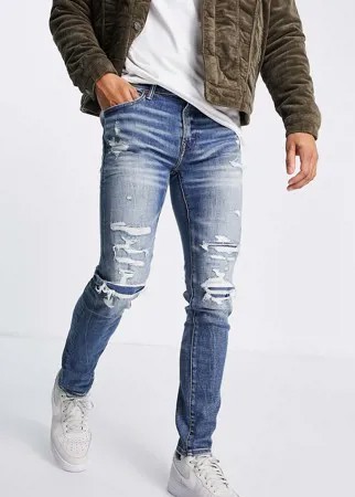 Выбеленные зауженные джинсы с рваной отделкой и заплатками American Eagle-Голубой